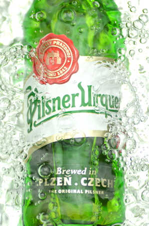 Pilsner Urquell pale lager beer in splashed water.のeditorial素材
