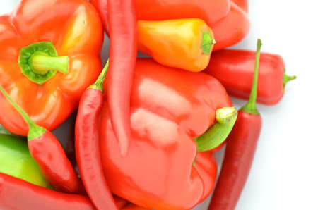 variety of raw peppers isolated on white backgroundの写真素材