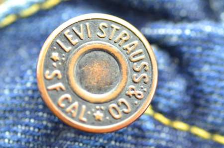 Closeup of Levi Strauss button on blue jeansのeditorial素材