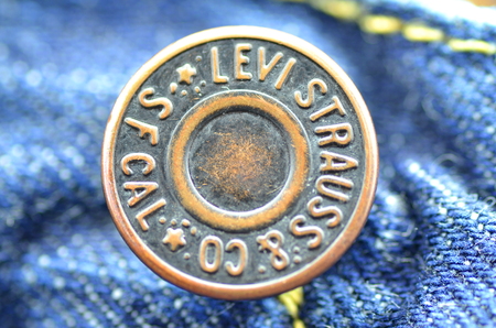 Closeup of Levi Strauss button on blue jeans.のeditorial素材