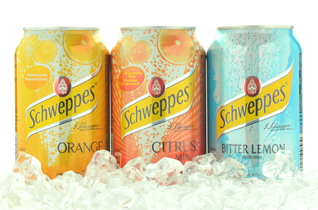 Cans of Schweppes drink on ice cubesのeditorial素材