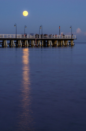 moon over pier in gdynia orlowo on Baltic sea in poland, europeの写真素材