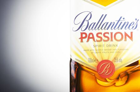 Ballantines passion spirit drink on gradient background. Ballantines is blended scotch whiskey produced produced by Pernod Ricard in Dumbarton, Scotland.のeditorial素材