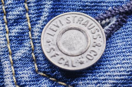 Closeup of Levi Strauss button on blue jeansのeditorial素材