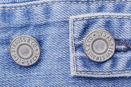 Closeup of Levi Strauss button on blue jeansのeditorial素材