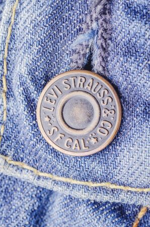 Closeup of Levi Strauss button on blue jeansのeditorial素材