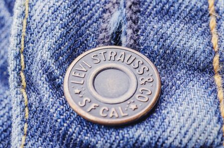 Closeup of Levi Strauss button on blue jeansのeditorial素材