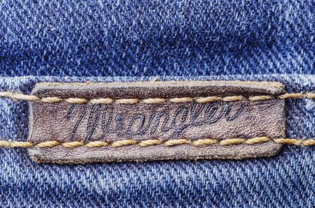 Closeup of Wrangler label on blue jeans.