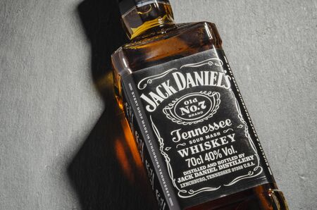 Bottle of Jack Daniels whiskey isolated on stone slate background.のeditorial素材
