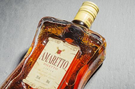Bottle of Amaretto liqueur on stone slate backgroundのeditorial素材