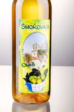 Bottle of fig flavored rakija isolated on gradient background produced in Omis, Croatia. Rakija is most commonly made out of grapes in Balkan countries.のeditorial素材