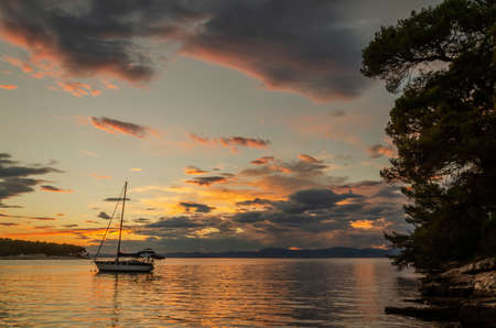 Moody clouds clouds during sunset over Adriatic bay in Splitska on Brac island in Croatiaの写真素材