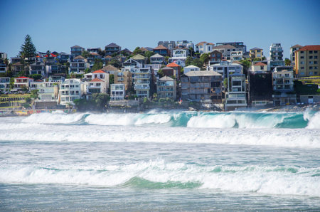 Picturesque golden sandy Bondi Beach in Sydney, Australia. Bondi beach is the perfect place for surfers due to constantly rising high waves.の写真素材