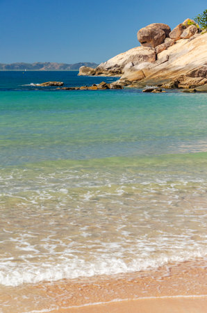 Picturesque golden sandy Alma Beach with granite boulders and turquoise water on Magnetic Island, Queensland, Australia. It is a holiday destination 8 km offshore of Townsville.の写真素材
