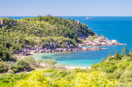Picturesque golden sandy Arthur Beach with granite boulders and turquoise water on Magnetic Island, Queensland, Australia. It is a holiday destination 8 km offshore of Townsville.の写真素材