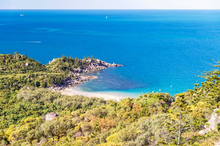 Picturesque golden sandy Arthur Beach with granite boulders and turquoise water on Magnetic Island, Queensland, Australia. It is a holiday destination 8 km offshore of Townsville.の写真素材