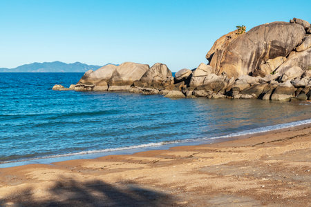 Picturesque golden sandy Arthur Beach with granite boulders and turquoise water on Magnetic Island, Queensland, Australia. It is a holiday destination 8 km offshore of Townsville.の写真素材
