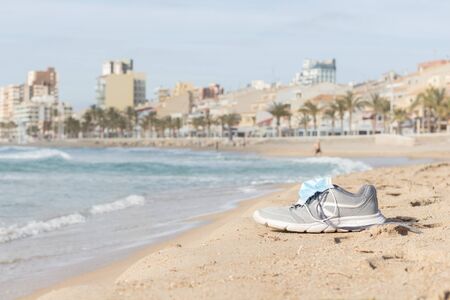 some slippers on the shore of the beach with a mask on top of themの写真素材