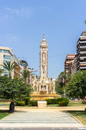 Alicante, Spain; June 30, 2020; General Marva's street is busy with pedestrians, surrounded by palm trees and buildings with a blue sky on a sunny day of summerのeditorial素材
