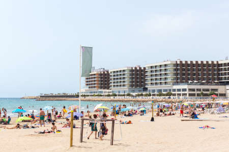 Alicante, Spain; July 08, 2020; Postiguet beach full of people sunbathing and swimming in the water on a sunny summer dayのeditorial素材