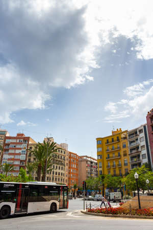 Alicante, Spain; June 30, 2020; La plaza de los luceros full of colorful buildings, surrounded by palm trees with a blue sky with clouds a day of sun in summer in alicanteのeditorial素材