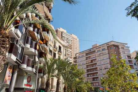 Alicante, Spain; July 15, 2020; horizontal shot from the plaza de levante to the surrounding buildings and palm trees on a day with a clear sky on a summer dayのeditorial素材