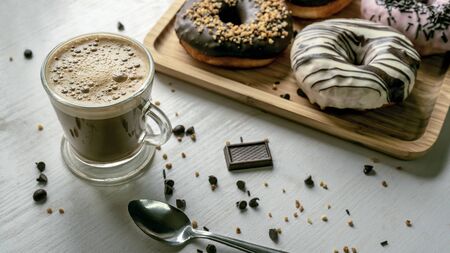 Coffee with donuts of different flavors. Appetizing donuts.の写真素材