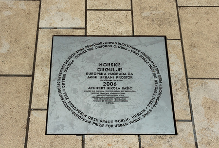 ZADAR, CROATIA - AUGUST 17, 2015: Inscription on metal plate on Zadar sea organs. Inscription says that the Sea Organ won European Prize for Urban Public Space award in 2006.のeditorial素材