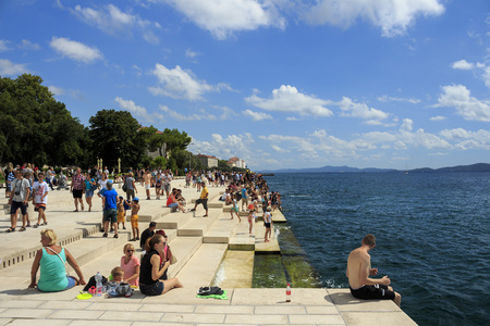 ZADAR, CROATIA - AUGUST 17, 2015: People relaxing and swimming at Zadar famoust Sea Organs. The sea organ won European Prize for Urban Public Space award in 2006.のeditorial素材