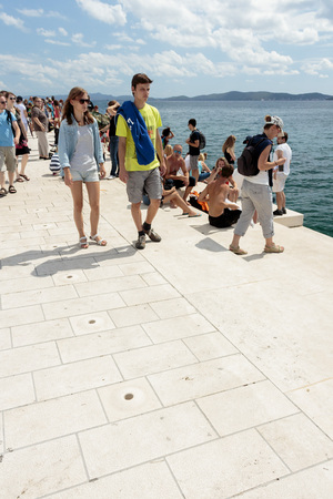 ZADAR, CROATIA - AUGUST 17, 2015: People walking on Greeting to the Sun sculpture. "Greeting to the Sun" by architect Nicola Basic, solar panels in Dalmatian town of Zadarのeditorial素材