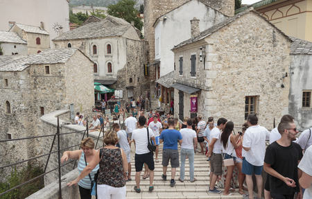 MOSTAR, BOSNIA AND HERZEGOVINA - AUGUST 14, 2015: Tourist and locals walking on Old bridge in Mostar. Included to the UNESCO heritageのeditorial素材