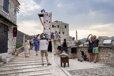 MOSTAR, BOSNIA AND HERZEGOVINA - AUGUST 14, 2015: Tourist and locals walking on Old bridge in Mostar. Included to the UNESCO heritageのeditorial素材