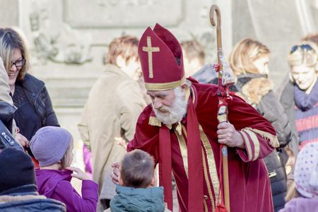 ZAGREB, CROATIA - DECEMBER 13, 2014: Advent in Zagreb, Croatia. St. Nicholas giving gifts to children.のeditorial素材