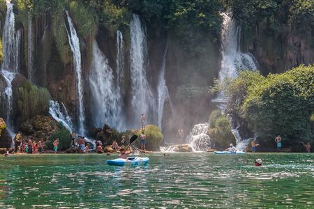 CAPLJINA, BOSNIA AND HERZEGOVINA - JULY 12, 2016: Kravica waterfall in Bosnia and Herzegovina. People swimming in river under waterfalls.のeditorial素材
