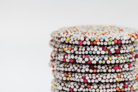 Round chocolate bar sprinkled with colorful sprinkles. Copy spaceの写真素材