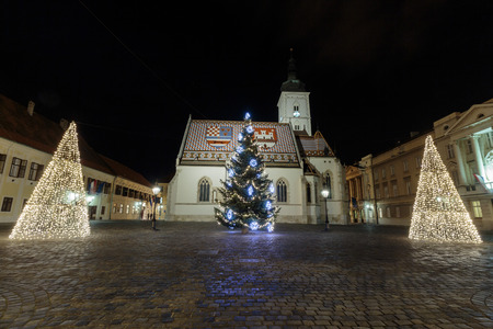 St. Marks square and st. Mark church with Christmas tree in front of it as part of Advent in Zagreb, Croatiaのeditorial素材