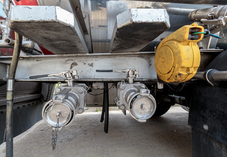 Valves on trailer tank used to dispense liquids like milk and all the way to dangerous goodsの写真素材
