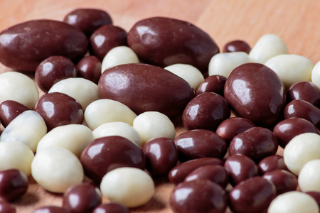 Chocolate dragee on wooden backgroundの写真素材