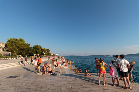 ZADAR, CROATIA - JULY 10, 2016: People relaxing and swimming at Zadar famoust Sea Organs. The sea organ won European Prize for Urban Public Space award in 2006.のeditorial素材