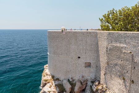 DUBROVNIK, CROATIA - JULY 13, 2016: Tourists looking at the Adriatic Sea from Dubrovnik city wallsのeditorial素材