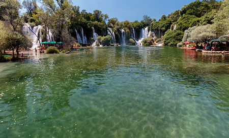CAPLJINA, BOSNIA AND HERZEGOVINA - JULY 12, 2016: Kravica waterfall in Bosnia and Herzegovina. People swimming in river under waterfalls.のeditorial素材