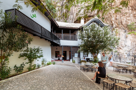 BLAGAJ, BOSNIA AND HERZEGOVINA - JULY 12, 2016: Blagaj Dervish House courtyard, Tekke on Buna river surrounded by many coffee shopsのeditorial素材