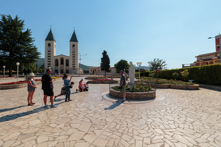 MEDUGORJE, BOSNIA AND HERZEGOVINA - JULY 12, 2016: Virgin Mary statue and the parish church of St. James, the shrine of Our Lady of Medugorjeのeditorial素材