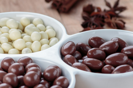 Chocolate dragee in porcelain bowlの写真素材