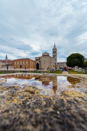 ZADAR, CROATIA - JULY 15, 2016: Church of St. Donatus, Zadar, a monumental building from the 9th century in Zadar, Croatia, reflection in waterのeditorial素材