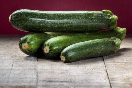Green zucchini on wooden tableの写真素材
