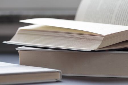 Open and closed book on top of eachother