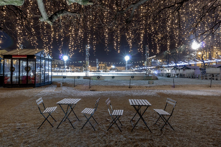 Advent in Zagreb, Snow covered chairs and tables in front of Ice Park and Christmas stands on King Tomislav parkのeditorial素材