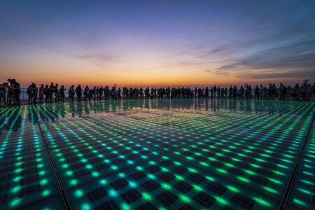 People silhouette on colorful sunset in Zadar, Dalmatia, Croatia