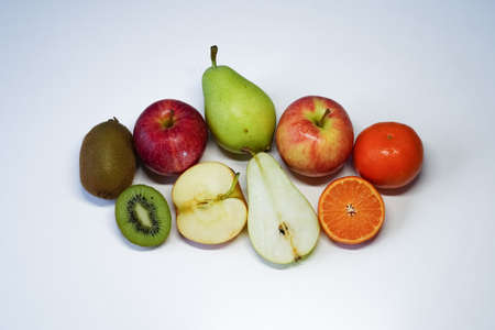 The fruit set of pears, apples, tangerines and kiwi cut and whole on white background. Top viewの写真素材